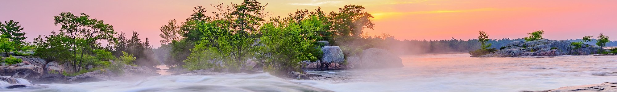 steam blanketing a river beneath sunset