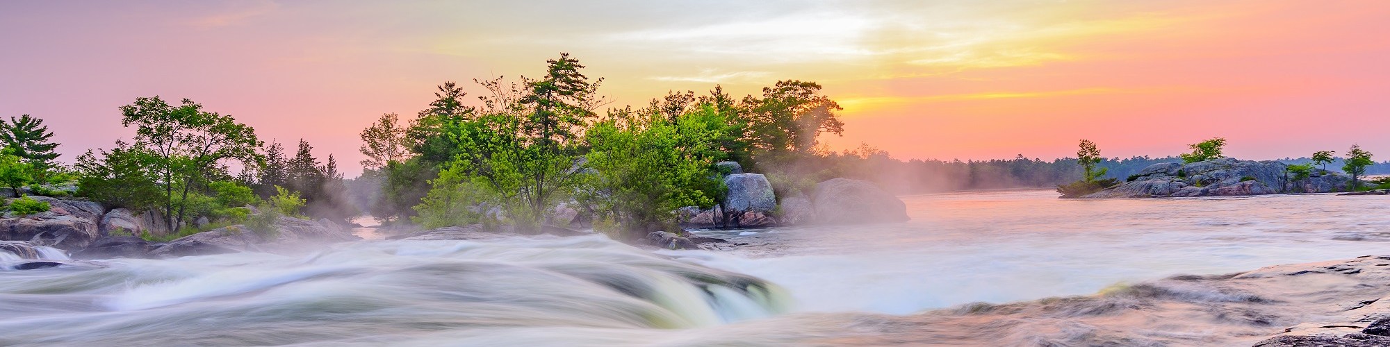 steam blanketing a river beneath sunset