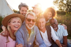 A group of friends sitting and smiling together